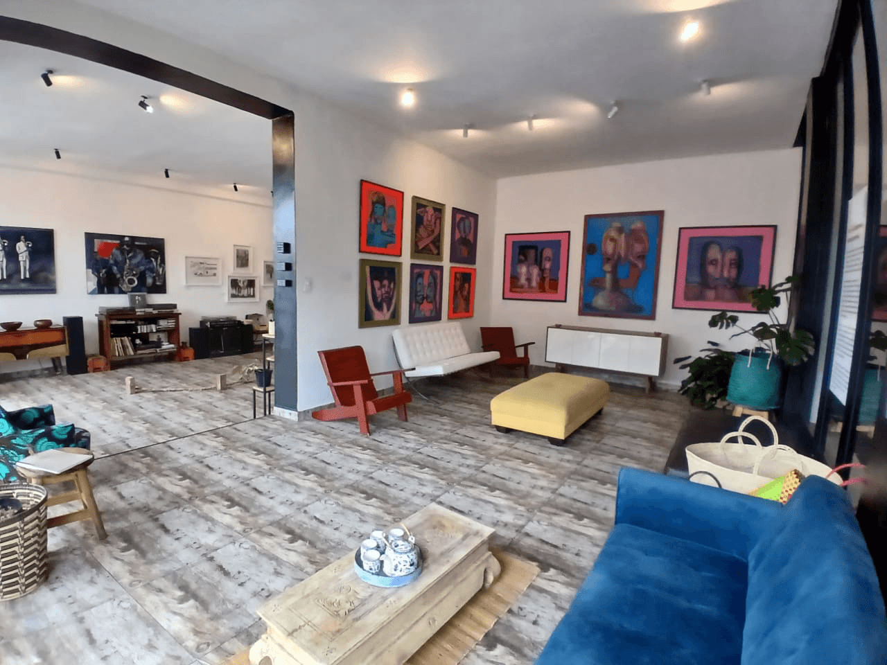 Interior view of the gallery with colorful framed artworks